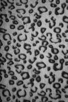 Soft fleecy faux fabric with a mottled pattern. Light leopard texture. photo