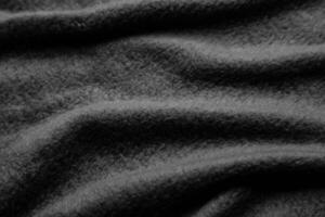 Texture of warm woolen fabric with folds. Gray wavy felt back. photo