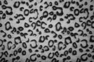 Soft fleecy faux fabric with a mottled pattern. Light leopard texture. photo