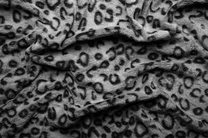 Soft fleecy faux fabric with a mottled pattern. Light leopard texture. photo