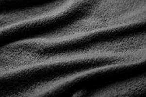 Texture of warm woolen fabric with folds. Gray wavy felt back. photo