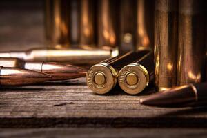 Close-up of .308 caliber rifle cartridges. Ammunition for weapons on a wooden surface. Dark back. photo