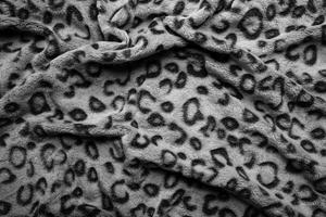 Soft fleecy faux fabric with a mottled pattern. Light leopard texture. photo