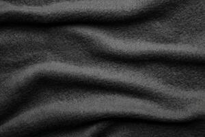 Texture of warm woolen fabric with folds. Gray wavy felt back. photo