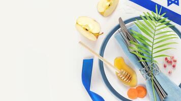 Rosh hashanah flat lay with table setting and traditional symbols photo