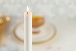 Rosh hashanah comnposition with a burning white candle photo