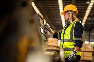 Factory engineer woman standing confident to control panel switch. Worker works at heavy machine at industry factory. worker checking timber of raw wood material. smart industry worker operating. photo