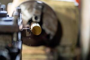 close up of machine operation for Metal Lathes. The steel column rolling in machine. metalworking industry. finishing metal working internal steel surface on lathe grinder machine with flying sparks photo