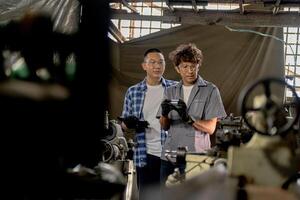 Men are inspecting steel parts for machine installation. team of teacher and student are learning to use heavy machines in steel factory. workers cooperate while doing quality control of manufactured. photo