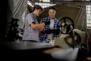 Men are inspecting steel parts for machine installation. team of teacher and student are learning to use heavy machines in steel factory. workers cooperate while doing quality control of manufactured. photo