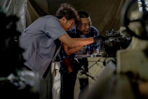 Men are inspecting steel parts for machine installation. team of teacher and student are learning to use heavy machines in steel factory. workers cooperate while doing quality control of manufactured. photo