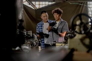 Men are inspecting steel parts for machine installation. team of teacher and student are learning to use heavy machines in steel factory. workers cooperate while doing quality control of manufactured. photo