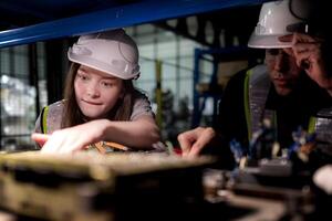 team engineers inspecting on machine with smart tablet. Worker works at heavy machine robot arm. The welding machine with a remote system in an industrial factory. Artificial intelligence concept. photo