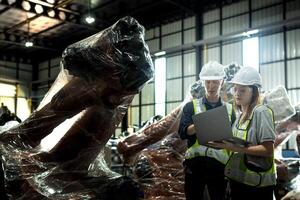 team engineers inspecting on machine with smart tablet. Worker works at heavy machine robot arm. The welding machine with a remote system in an industrial factory. Artificial intelligence concept. photo