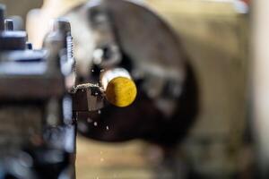 close up of machine operation for Metal Lathes. The steel column rolling in machine. metalworking industry. finishing metal working internal steel surface on lathe grinder machine with flying sparks photo