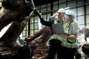 team engineers inspecting on machine with smart tablet. Worker works at heavy machine robot arm. The welding machine with a remote system in an industrial factory. Artificial intelligence concept. photo