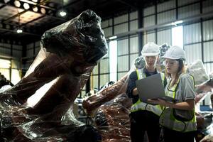 team engineers inspecting on machine with smart tablet. Worker works at heavy machine robot arm. The welding machine with a remote system in an industrial factory. Artificial intelligence concept. photo