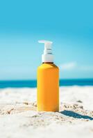 Sunscreen in a orange bottle with white dispensers on a sandy beach with a blue ocean backdrop and frangipani flower decoration photo