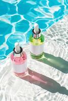 Cosmetic products in bottles with blank mock-up labels with blue water of the swimming pool on the background photo