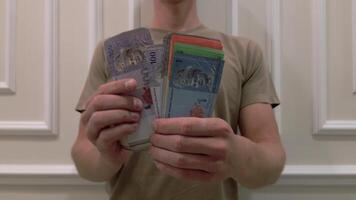 Man counting the Malaysian ringgit, close-up. video