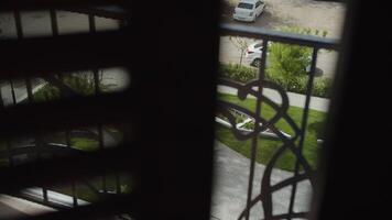 View of the yard through the roll shutter, view through curtains video