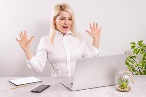 Euphoric and surprised winner winning online watching a laptop at home photo