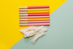 Multicolored cigarettes and snus pads on a paper background, the concept of a bad habit. photo