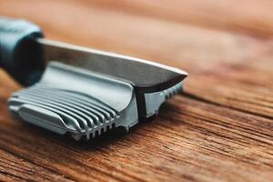 Manual knife sharpener on a wooden background photo
