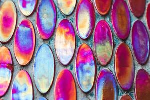 Texture of mother-of-pearl mosaic round tiles, close-up photo