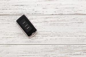 car keys, remote control on a wooden background photo
