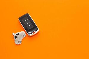 car keys, remote control on an orange background photo
