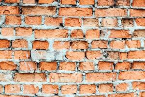wall of the house of the old red brick. texture and background for designers photo
