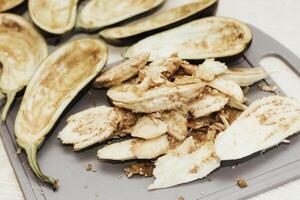 Eggplant cut without pulp on a white table before cooking photo