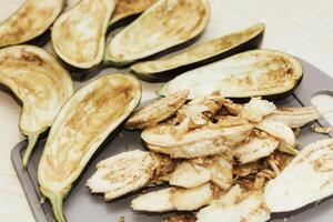 Eggplant cut without pulp on a white table before cooking photo