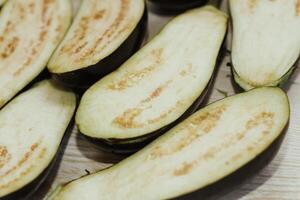 Eggplant cut without pulp on a white table before cooking photo