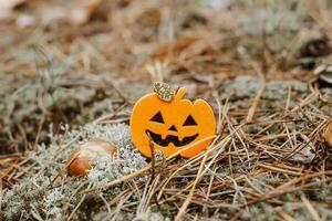 Toy ghost made of felt in the forest, Halloween decor photo
