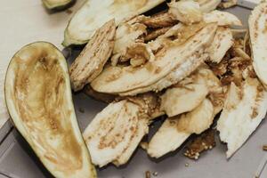 Eggplant cut without pulp on a white table before cooking photo