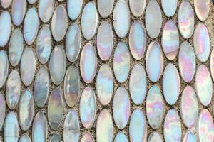 Texture of mother-of-pearl mosaic round tiles, close-up photo