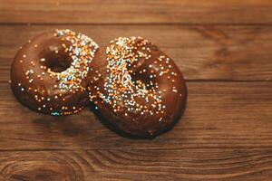 Round-shaped donuts with chocolate glaze and colored sprinkles photo