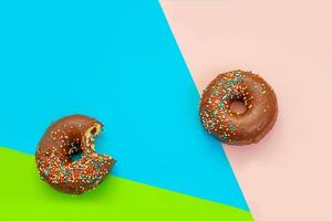 Round-shaped donuts with chocolate glaze and colored sprinkles photo