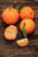 Tangerines on the background of a wooden brown table with boards photo