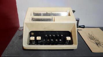 Retro Classic Vintage Mechanical Adding Machine on Display with Numeric Keys and Manual Crank in Historical Setting photo