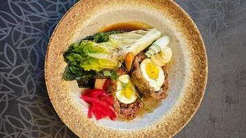 Delicious Wagyu Selat Solo Dish with Colorful Vegetables and Egg on Elegant Plate in Restaurant Setting photo