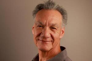 Close up Portrait of a Happy Mature Man Smiling photo