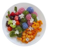 Various types of Thai desserts in white plate Look Choup, Kanom Chan, Thong Yip, Foi Thong, Met Khanun, Thong Yot, Khao Niew Kaew isolated on white background included clipping path. photo