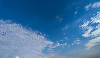 a view of the sky from a boat on a lake, a blue sky that has white some clouds photo
