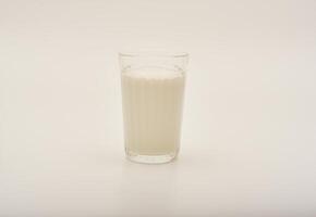 Melted milk in a glass on a white background. Milk in a bowl. photo