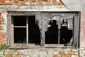 Old wall with windows in an abandoned room. photo