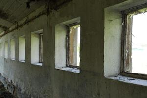 Old wall with windows in an abandoned room. photo