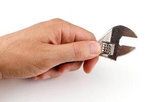 Metal adjustable wrench in hand isolate photo